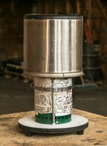 Wood gas stove with insulated pot. Foil provides additional insulation for the combustion chamber. 