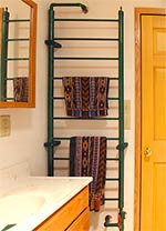 Hydronically heated towel rack
